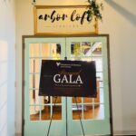 Poster that reads Volunteers of America Annual Gala sits on an easel in front of the entrance to the Arbor Loft event space.