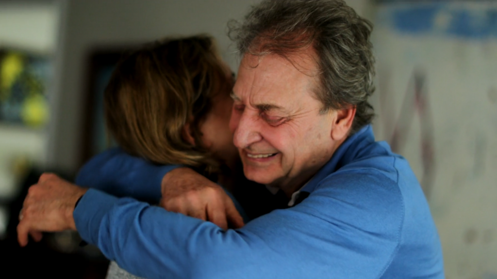 A smiling older man in a blue shirt hugs an older woman in gratitude.
Caring Gift of Second Chances