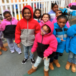 Students at the VOA Children's Center pose with their new winter coats donated by Van Bortel Subaru as part of Operation Warm.