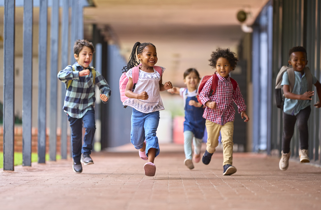 Kids running down a school hallways.