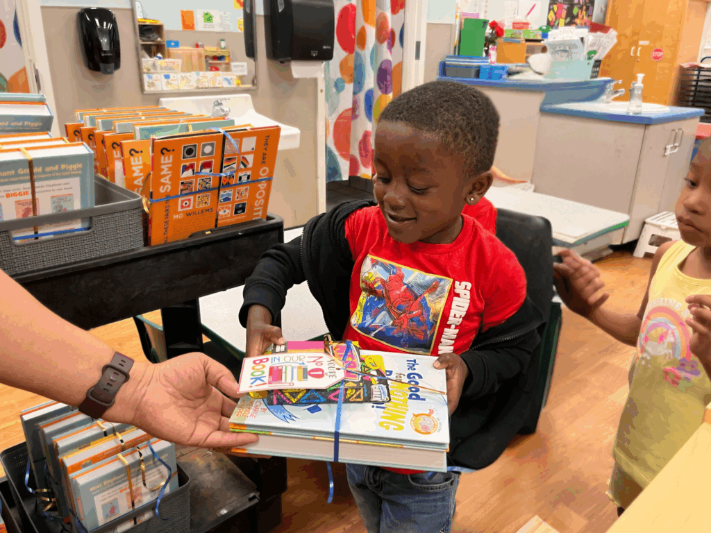 Pre-school age child receives books