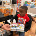 Pre-school age child receives books