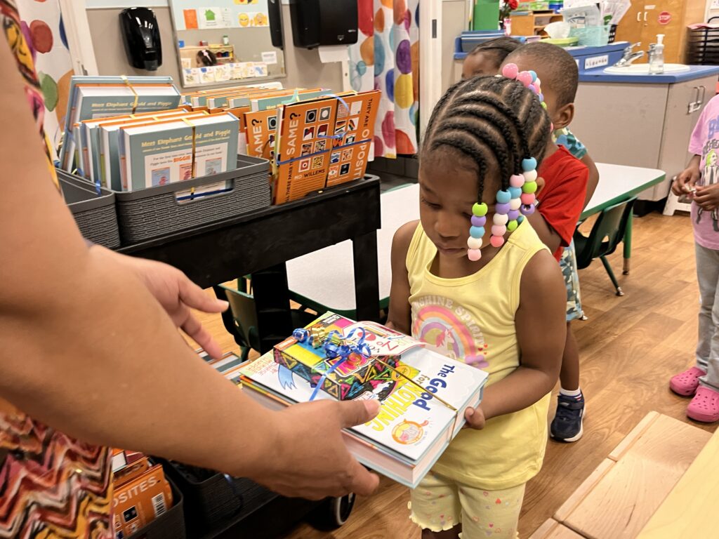pre-school age child receives books