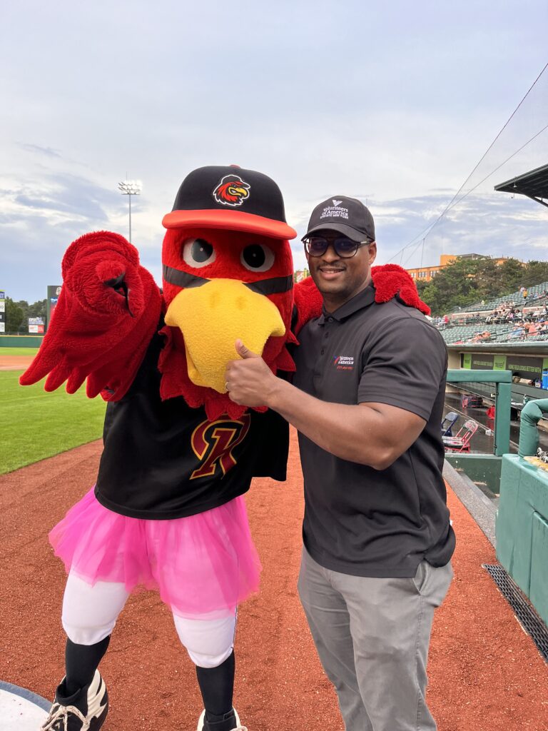 Dr. Junior Dillion poses with Rochester Red Wings mascot Spike.