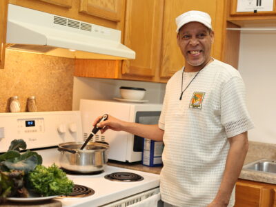 Smiling man cooking in this kitchen
