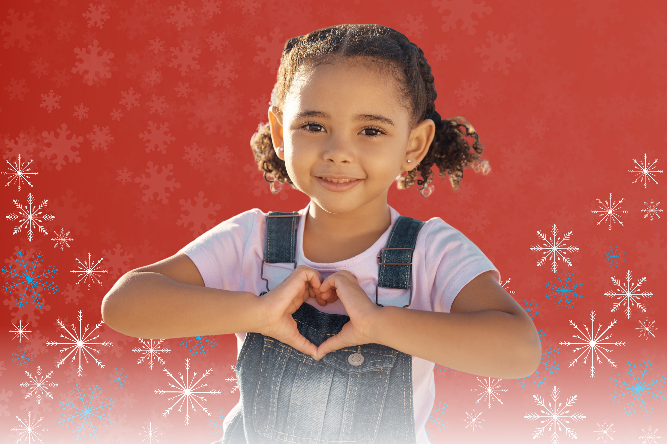 Young girl holds her hands in the shape of a heart.